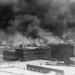 In this historical image from 1921, courtesy of the Library of Congress, smoke rises over Tulsa, Oklahoma, amid the Tulsa Race Massacre—recognized as one of the most horrific acts of violence against Black individuals in U.S. history. (Source: Alvin C. Krupnick Co./AP)