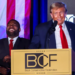 U.S. Congressman Byron Donalds chuckles while former President and Republican presidential candidate Donald Trump gives a keynote address at the Black Conservative Federation gala dinner on February 23, 2024. [Alyssa Pointer/Reuters]