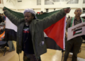 FILE - Jabari Shaw waves a Palestinian flag during an Oakland Unified School District board meeting at La Escuelita Elementary School in Oakland, California, on Wednesday, November 8, 2023. (Jane Tyska/Bay Area News Group via AP)