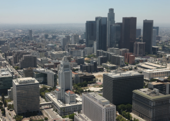 An aerial shot of the Los Angeles skyline, with the Los Angeles City Hall prominently visible in the foreground, captured on July 13, 2010. (Tom Szczerbowski/Getty Images)