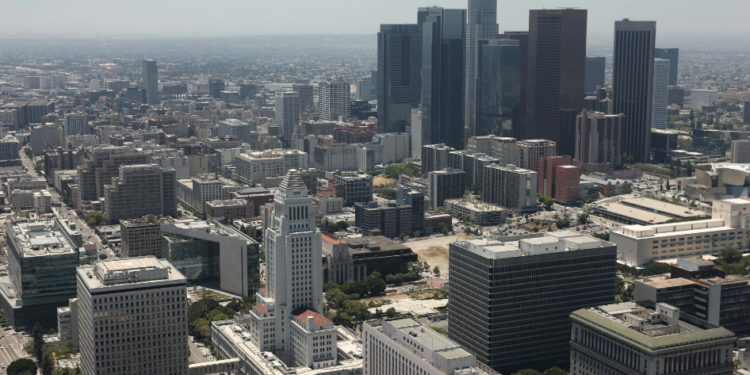An aerial shot of the Los Angeles skyline, with the Los Angeles City Hall prominently visible in the foreground, captured on July 13, 2010. (Tom Szczerbowski/Getty Images)