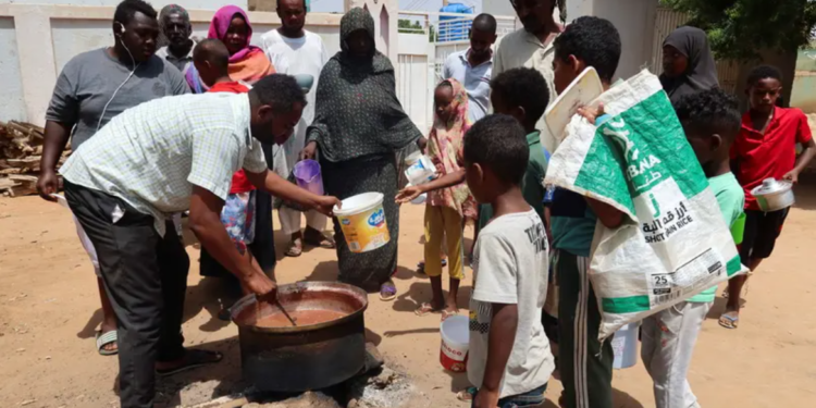 A volunteer stirs food prepared for distribution to people in Omdurman, Sudan, on September 3, 2023. (File photo: Reuters)