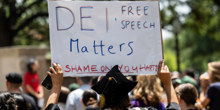 Protesters rally against DEI-related staff dismissals at UT Austin on April 29. Michael Minasi / KUT News
