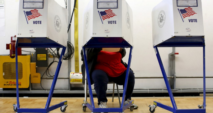 A person fills out a ballot at the polling center located at the James Weldon Johnson Community Center during the New York primary elections in East Harlem, New York City, on April 19, 2016. Photo by Andrew Kelly/Reuters.