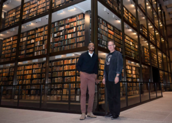 Tubyez Cropper and Michael Morand pose together inside Yale's Beinecke Rare Book & Manuscript Library on Wednesday, Oct. 9, 2024, in New Haven, Connecticut. (Jessica Hill/AP)