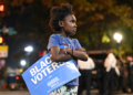 A young girl proudly holds a "Black Voters for Harris-Walz" sign outside the election night watch party for Democratic presidential nominee Vice President Kamala Harris at Howard University in Washington on Tuesday, Nov. 5. (AP photo/Terrance Williams)