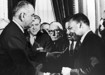 On August 6, 1965, U.S. President Lyndon B. Johnson hands a pen to Reverend Martin Luther King Jr. during the signing of the Voting Rights Act, which ruled literacy tests unconstitutional. (Washington Bureau / Getty Images)