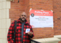 Outside the polling station at Joseph Lovett Elementary School, located at 6333 W. Bloomingdale Ave. in Austin, Roger Carter shows off his voting sticker on Nov. 5. (Credit: Michael Liptrot/Block Club Chicago)