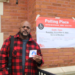 Outside the polling station at Joseph Lovett Elementary School, located at 6333 W. Bloomingdale Ave. in Austin, Roger Carter shows off his voting sticker on Nov. 5. (Credit: Michael Liptrot/Block Club Chicago)
