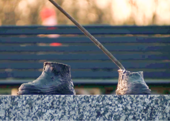 "In this video still provided by WXYZ, only the feet remain of a 600-pound bronze statue of a Tuskegee airman after it was stolen from a Detroit city park on Friday. (WXYZ via AP)"