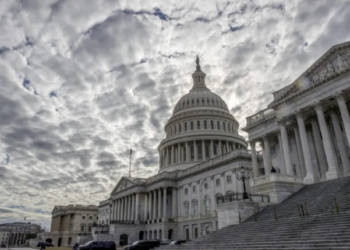 The Capitol stands beneath cloudy skies on the second day of the federal shutdown in Washington, Sunday, January 21, 2018. (AP Photo/J. Scott Applewhite)