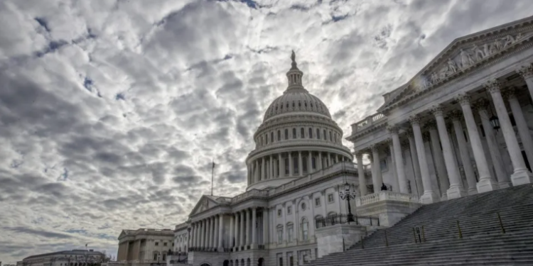 The Capitol stands beneath cloudy skies on the second day of the federal shutdown in Washington, Sunday, January 21, 2018. (AP Photo/J. Scott Applewhite)