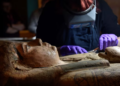 A conservator carefully cleans the 2,700-year-old sarcophagus of Ta-Kr-Hb. Photograph: Julie Howden