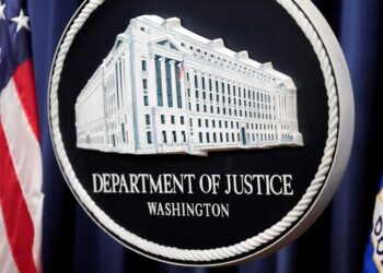 The Justice Department logo is displayed ahead of a news conference at the Department of Justice on Aug. 23, 2024, in Washington. (AP Photo/Mark Schiefelbein, File)