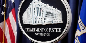 The Justice Department logo is displayed ahead of a news conference at the Department of Justice on Aug. 23, 2024, in Washington. (AP Photo/Mark Schiefelbein, File)