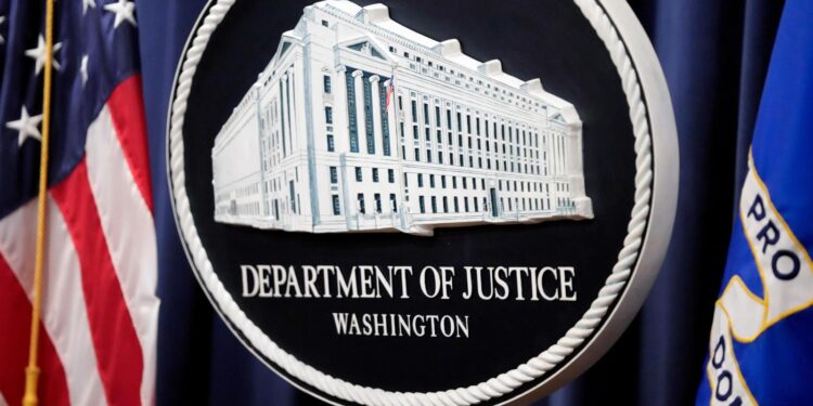The Justice Department logo is displayed ahead of a news conference at the Department of Justice on Aug. 23, 2024, in Washington. (AP Photo/Mark Schiefelbein, File)