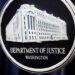 The Justice Department logo is displayed ahead of a news conference at the Department of Justice on Aug. 23, 2024, in Washington. (AP Photo/Mark Schiefelbein, File)