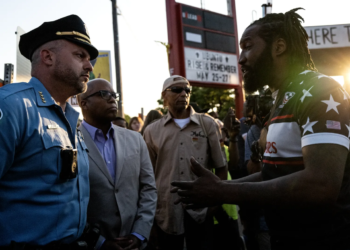 Minneapolis Police Chief Brian O'Hara (left) and former Chief Medaria Arradondo (second from left) participate in a vigil at George Floyd Square in May 2023. (Photo: Stephen Maturen/Getty Images)