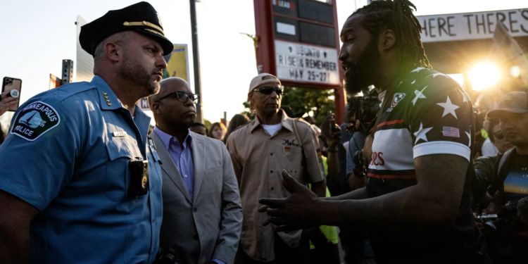 Minneapolis Police Chief Brian O'Hara (left) and former Chief Medaria Arradondo (second from left) participate in a vigil at George Floyd Square in May 2023. (Photo: Stephen Maturen/Getty Images)