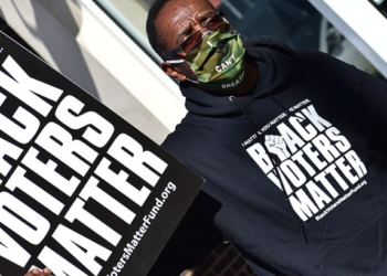 A Black voter in Graham, North Carolina, on November 3, 2020. Photo by Anthony Crider, shared under a Creative Commons license via Wikimedia Commons.
