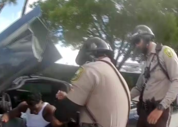 A body cam screenshot shows officers from the Miami-Dade Police Department pulling Miami Dolphins player Tyreek Hill from his car following a speeding stop on September 9, 2024.