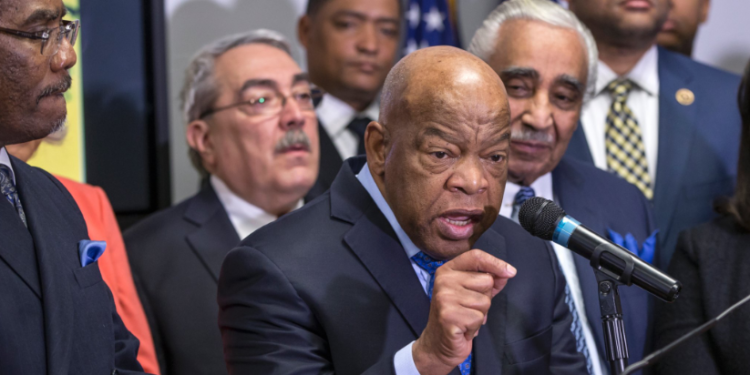 Rep. John Lewis (D-Ga.) endorsed Hillary Clinton alongside the Congressional Black Caucus Political Action Committee on February 11, 2016. The endorsement event was captured in a photograph by J. Scott Applewhite for the Associated Press.