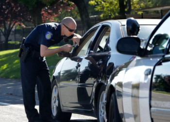 A police officer conducts a traffic stop in Sacramento. (Rich Pedroncelli / Associated Press)