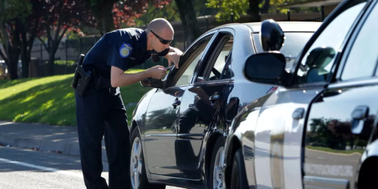A police officer conducts a traffic stop in Sacramento. (Rich Pedroncelli / Associated Press)