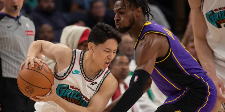 Los Angeles Lakers guard Bronny James (right) and Memphis Grizzlies guard Yuki Kawamura, from Japan, are pictured during the second half of an NBA basketball game in Memphis, Tennessee, on November 6. James made his return to basketball after experiencing a cardiac arrest during practice in July 2023. (Nikki Boertman/AP)