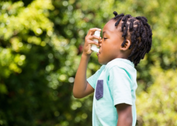 A young boy using an asthma inhaler | Image courtesy of WavebreakmediaMicro | stock.adobe.com