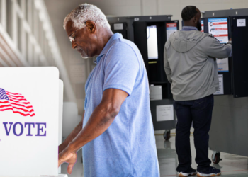 Black men casting their votes at election booths. (Photo illustration by Jack Forbes; images: Getty Images, Alex Wong/Getty Images) (Getty Images)