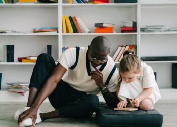 a man teaching a child