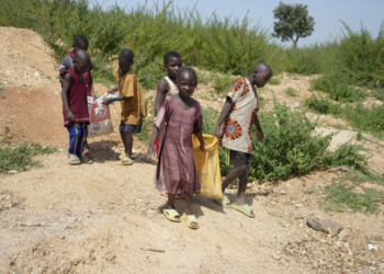 Six-year-old Juliet Samaniya carries a bag of lithium alongside other children at an unauthorized mining site in Paseli, Nigeria, on Tuesday, November 5, 2024. (AP Photo/Sunday Alamba)
