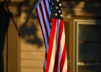 american flag in sunlight outside kansas home
