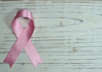 breast cancer awareness on teal wooden surface