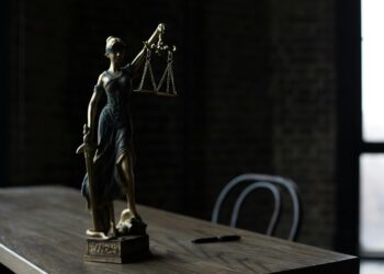 a figurine of the lady justice on a table