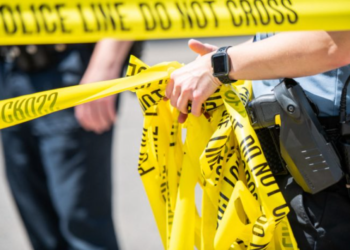 Police remove crime scene tape. (Image credit: Brandon Bell/Getty Images.)