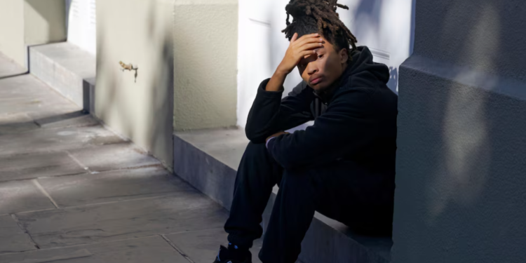 Trevant Hayes, 20, sits in the French Quarter grieving the loss of his friend, 18-year-old Nikyra Dedeaux, after a pickup truck plowed into pedestrians on Bourbon Street, followed by a shooting in New Orleans' French Quarter on Wednesday, January 1, 2025. (AP Photo/Matthew Hinton) – The Associated Press