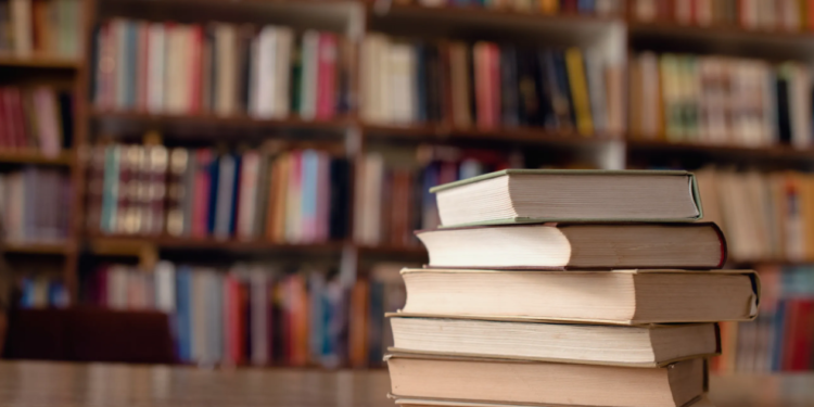 A close-up view of books on a desk in a library. (Getty Images)