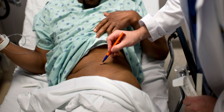 A doctor at Johns Hopkins Hospital labels the kidney to be removed from a living Black donor in this 2012 photo. Brendan Smialowski/AFP/Getty Images/File
