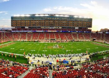 nfl stadium field full with crowd watching the game during daytime