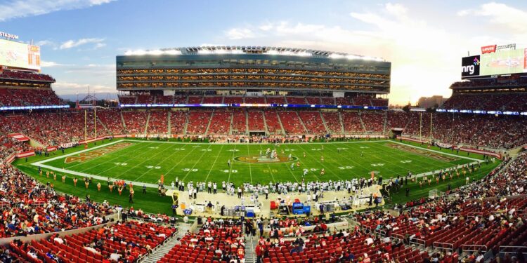 nfl stadium field full with crowd watching the game during daytime