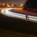 time lapse photography of fast moving cars on the road during night time