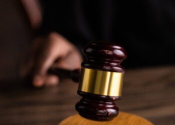 brown and gold gavel on brown wooden table