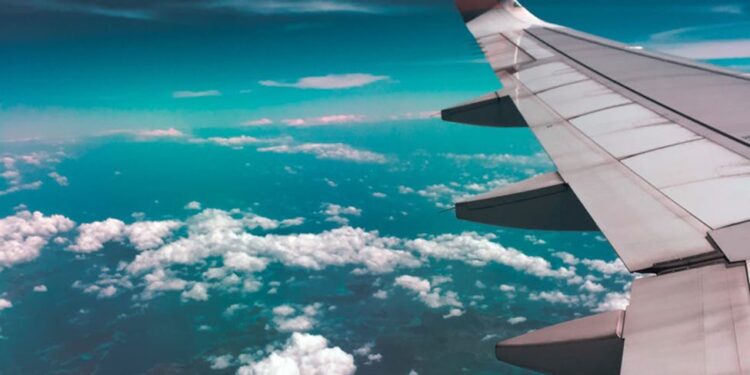 airplane wing above clouds