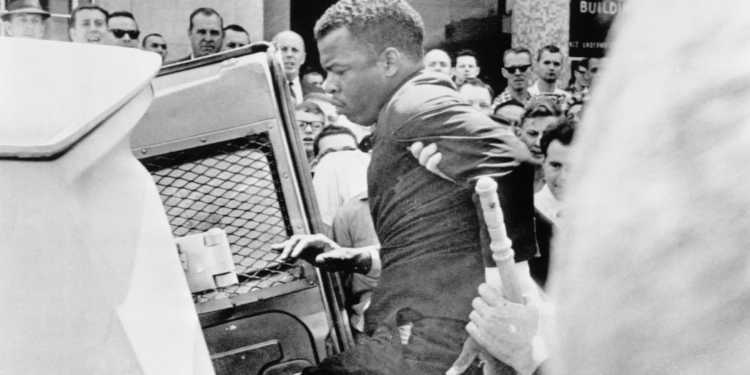 John Lewis, 24, chairman of the SNCC, is escorted into a police wagon during a protest on April 29, 1964. On the same day, Nashville’s mayor announced that U.S. Attorney General Robert Kennedy had initiated an investigation into police brutality against over 200 demonstrators. Photo: Bettmann via Getty Images.