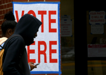 Voters at Alabama A&M University walk past a voting sign after casting their ballots at Elmore Gym on Election Day, Tuesday, Nov. 5, 2024, in Huntsville, Alabama. According to a report from the Brennan Center, the racial voting gap between white, Black, and nonwhite voters in Alabama has reached its widest point in two decades. (Eric Schultz for Alabama Reflector)