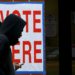 Voters at Alabama A&M University walk past a voting sign after casting their ballots at Elmore Gym on Election Day, Tuesday, Nov. 5, 2024, in Huntsville, Alabama. According to a report from the Brennan Center, the racial voting gap between white, Black, and nonwhite voters in Alabama has reached its widest point in two decades. (Eric Schultz for Alabama Reflector)