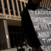 A demonstrator stands outside the Department of Education headquarters in Washington, D.C., on March 12, following the agency’s announcement of plans to lay off nearly half its workforce. The move, which some fear could signal an eventual shutdown, comes as government agencies rush to meet President Donald Trump’s deadline for submitting proposals for a second wave of mass layoffs. (Nathan Howard/Reuters)
