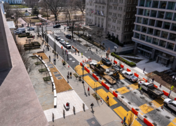 The demolition of the Black Lives Matter mural begins in Washington on Monday, March 10, 2025, with the White House visible in the top left. (AP Photo/Jacquelyn Martin)